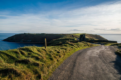 Road by sea against sky