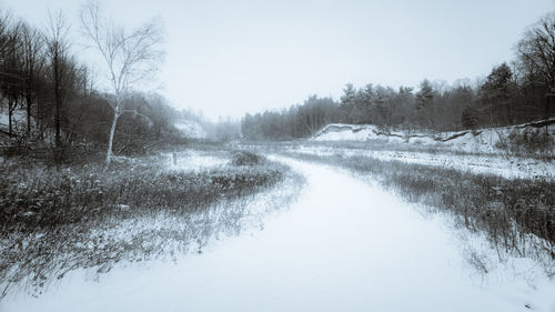 Scenic view of snow covered landscape against clear sky