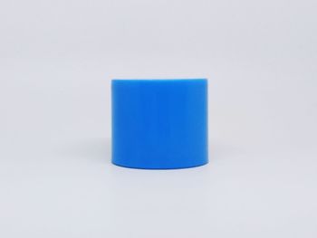 Close-up of blue object over white background