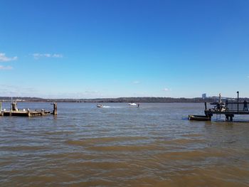 Scenic view of sea against blue sky