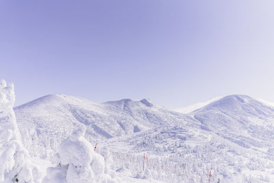 Scenic view of snowcapped mountains against clear blue sky