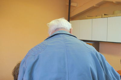 Close-up of woman standing against wall