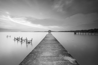 Pier over lake against sky