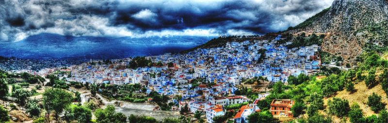 Scenic view of mountains against cloudy sky