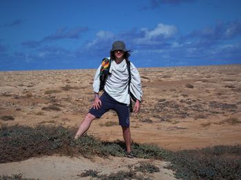 Full length of man wearing hat against sky