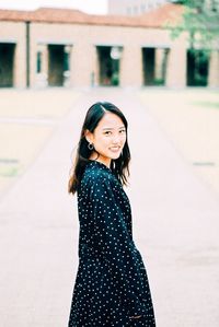 Portrait of a smiling young woman in city