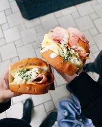 High angle view of person holding burger