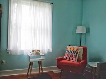 Empty chairs against wall at home