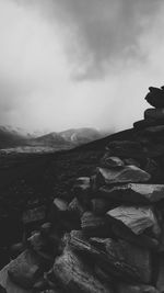 Scenic view of mountains against cloudy sky