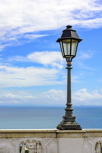 Close-up of street light by sea against sky at salvador city in brazil