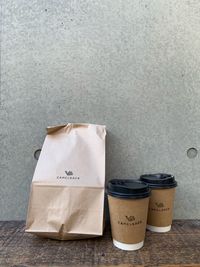 Close-up of coffee cup on table against wall