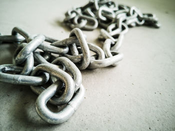 Close-up of chain tied on metal table