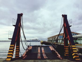Bridge by sea against sky