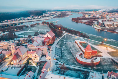 High angle view of buildings in town against sky