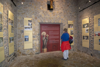 Full length rear view of man standing against building