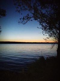 Scenic view of lake against sky at sunset