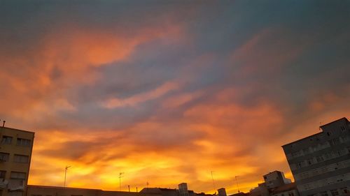 High section of building against cloudy sky at sunset