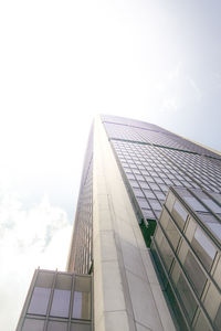 Low angle view of glass building against sky