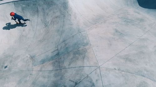 High angle view of boy with push scooter in skateboard park