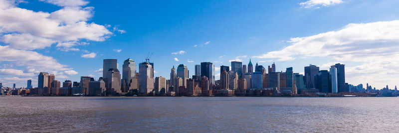 Panoramic view of sea and buildings against sky