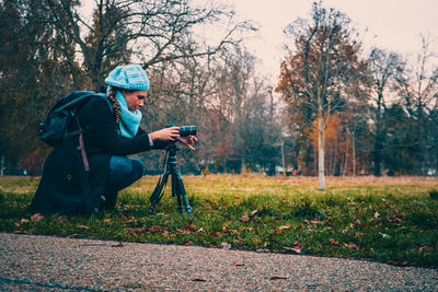 Woman photographing in park