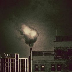 Low angle view of building against cloudy sky