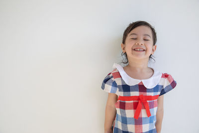 Portrait of a smiling girl over white background