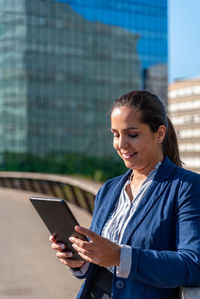 Mid adult woman using mobile phone