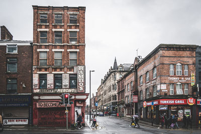 View of city street and buildings against sky