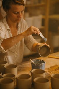 Cropped hands of man preparing food in workshop