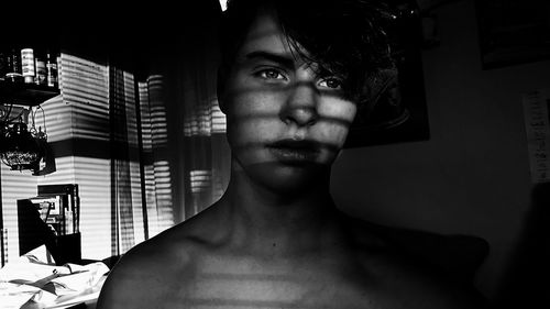 Portrait of young man at home