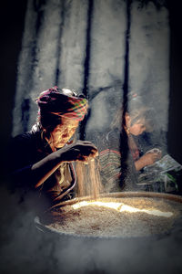 High angle view of woman holding burning fire