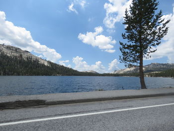 Scenic view of lake by trees against sky