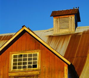 Low angle view of old building against clear blue sky