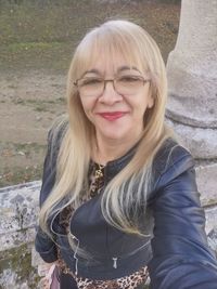 Portrait of smiling young woman standing outdoors