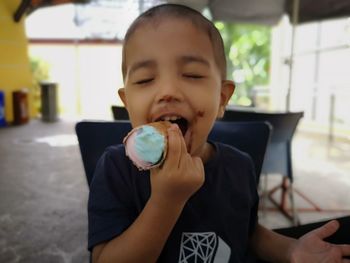 Portrait of boy eating food