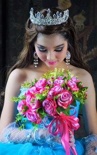 Beautiful woman holding flower bouquet