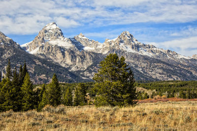 Scenic view of mountains against cloudy sky