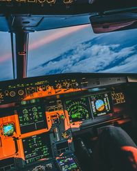 Close-up of airplane flying against cloudy sky