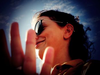 Close-up portrait of smiling young woman looking away