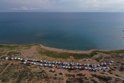 High angle view of crowd by sea against sky