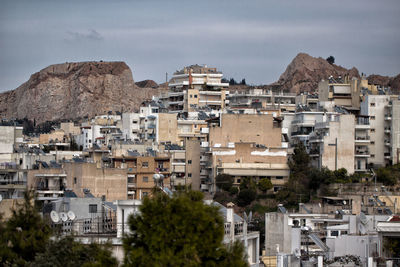 Buildings in town against sky