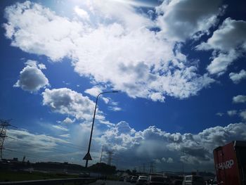 Low angle view of street and buildings against sky