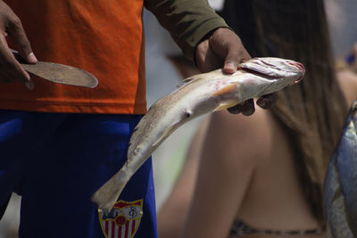 Close-up of man holding fish