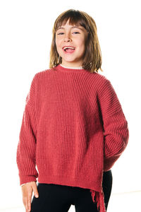 Portrait of young woman standing against white background