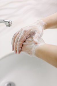 Woman washes her hands by surgical hand washing method. she washes his