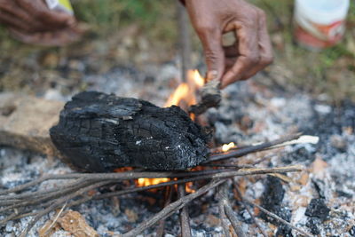 Close-up of hand holding burning outdoors