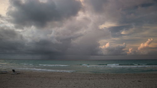Scenic view of sea against storm clouds