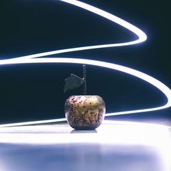 Close-up of apple on table against black background