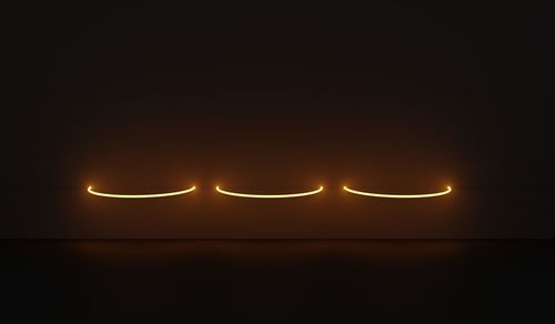 Close-up of illuminated lights against black background